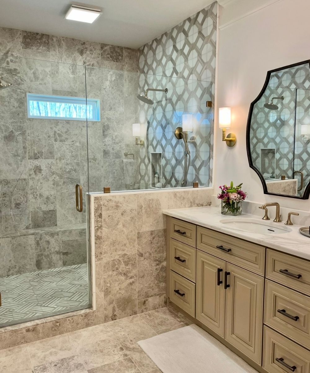 Modern bathroom with shower, vanity, and decorative tile.