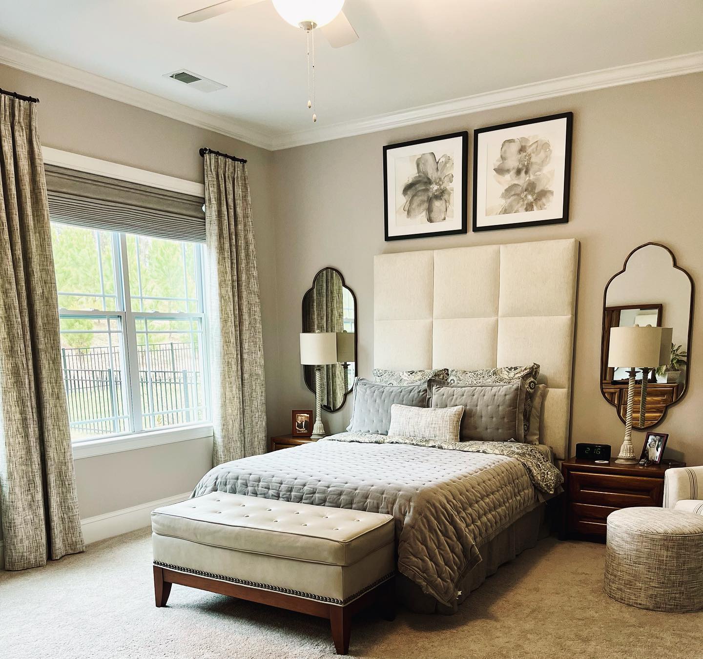 A completed bedroom design project featuring a custom headboard and window treatments by interior designer, Lori Savio