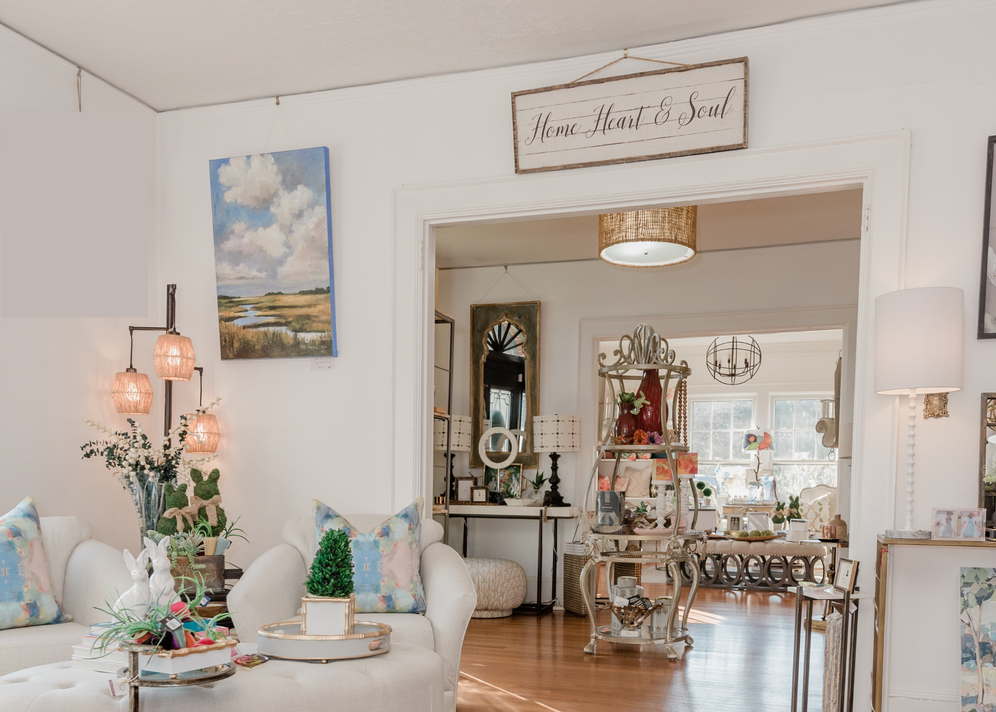 Photo of the inside of Home, Heart, & Soul, a home décor & gift shop in Cornelius, North Carolina. The photos features artwork, furniture, and home accessories available for purchase.