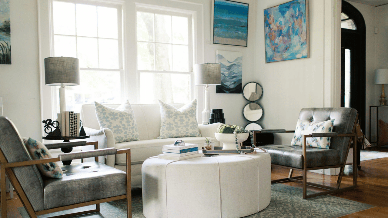 Modern living room in the Home, Heart & Soul boutique design center with white sofa, gray chairs, and decorative artwork.